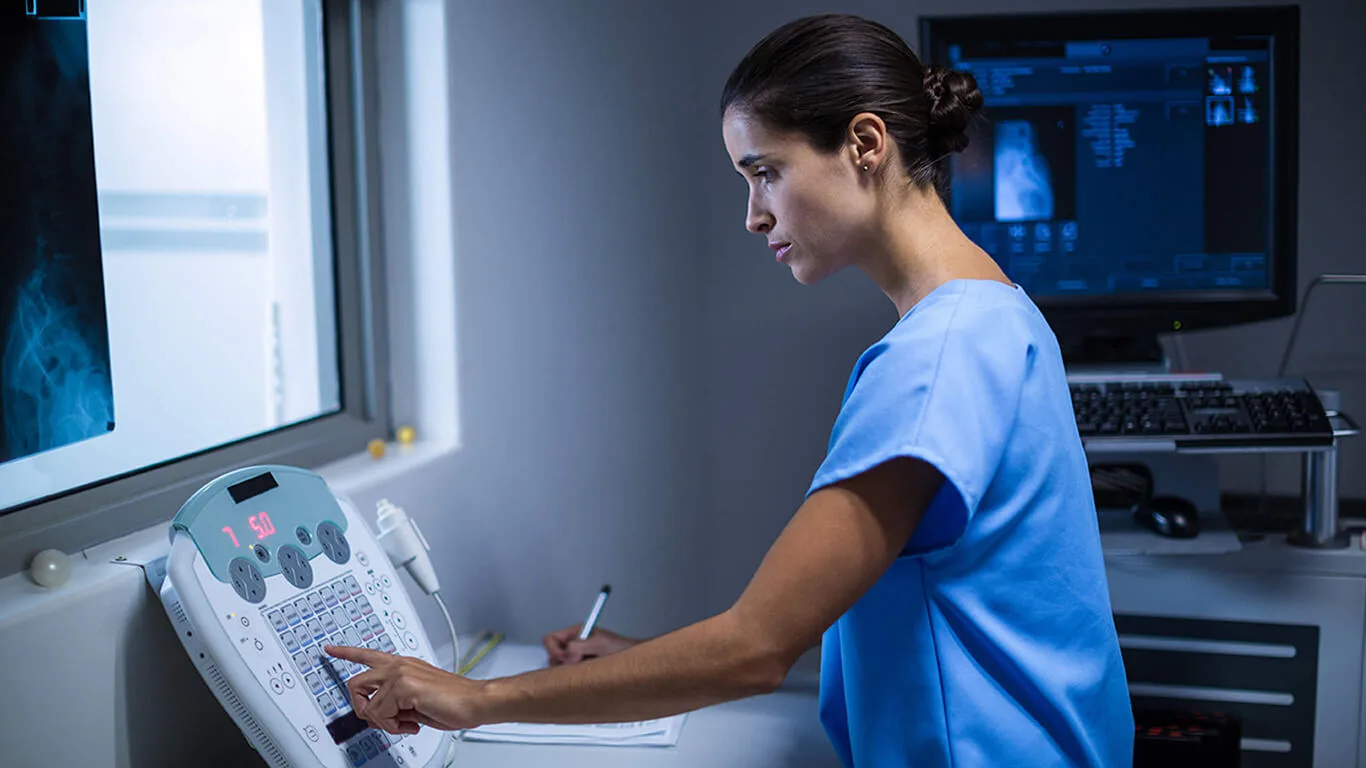 image shows woman working with medical device