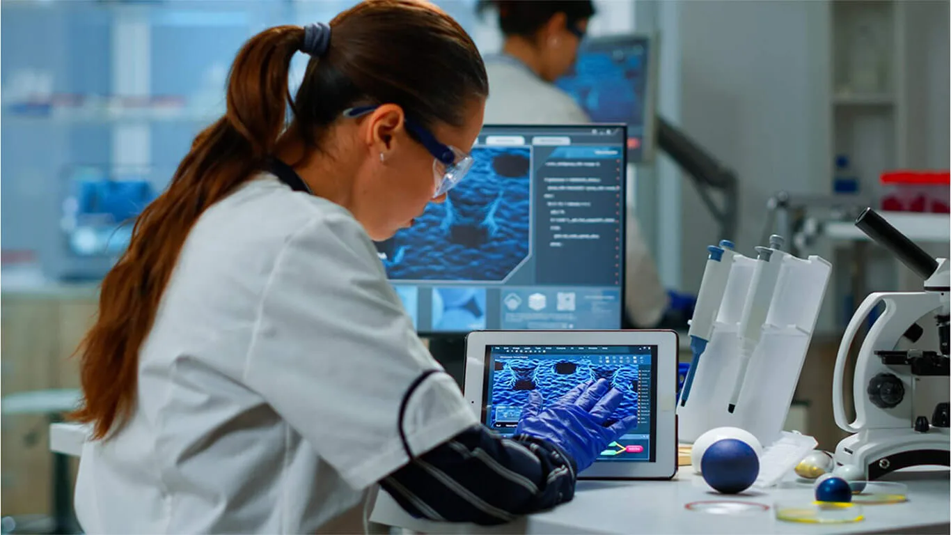 image shows woman working with medical computer in tech