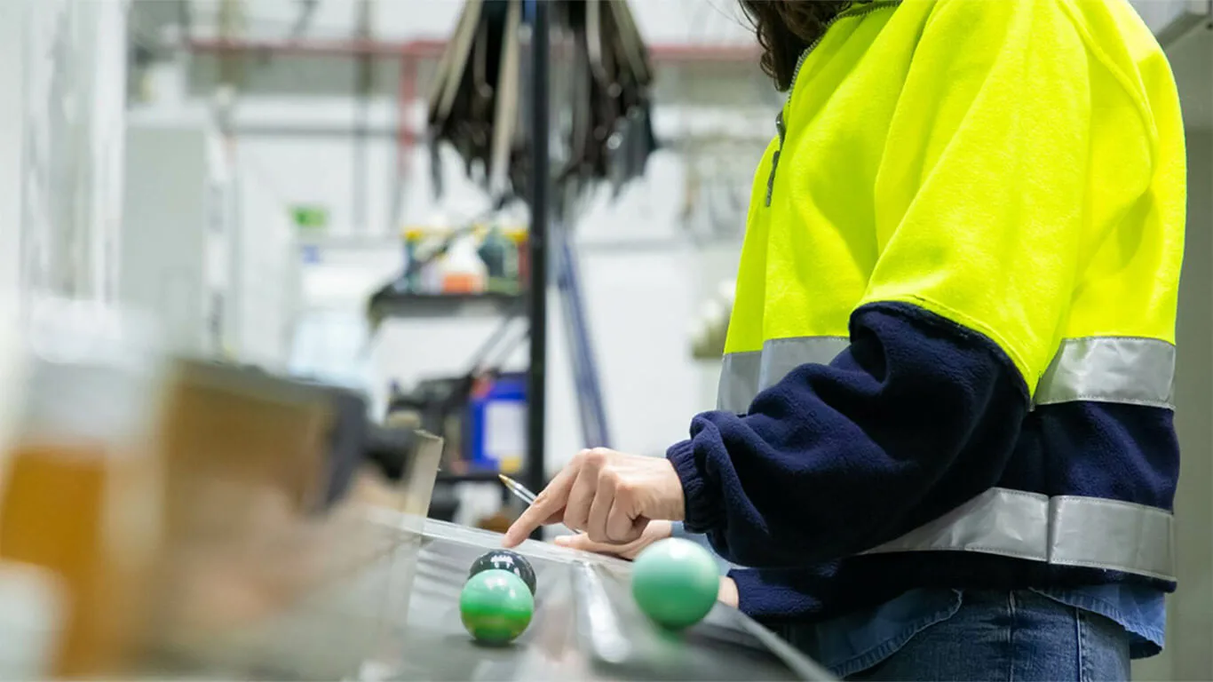 image shows person working on industrial machinery