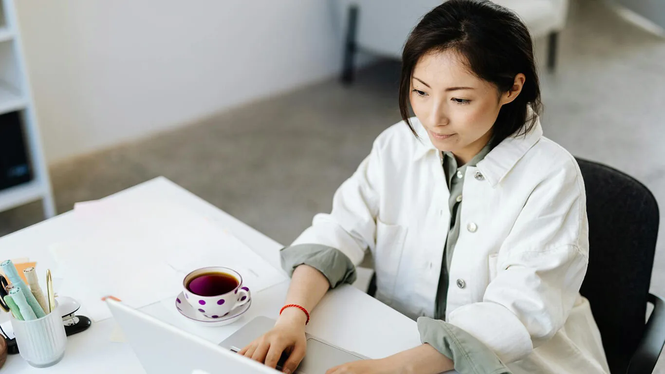 Image shows woman writing technical documentation