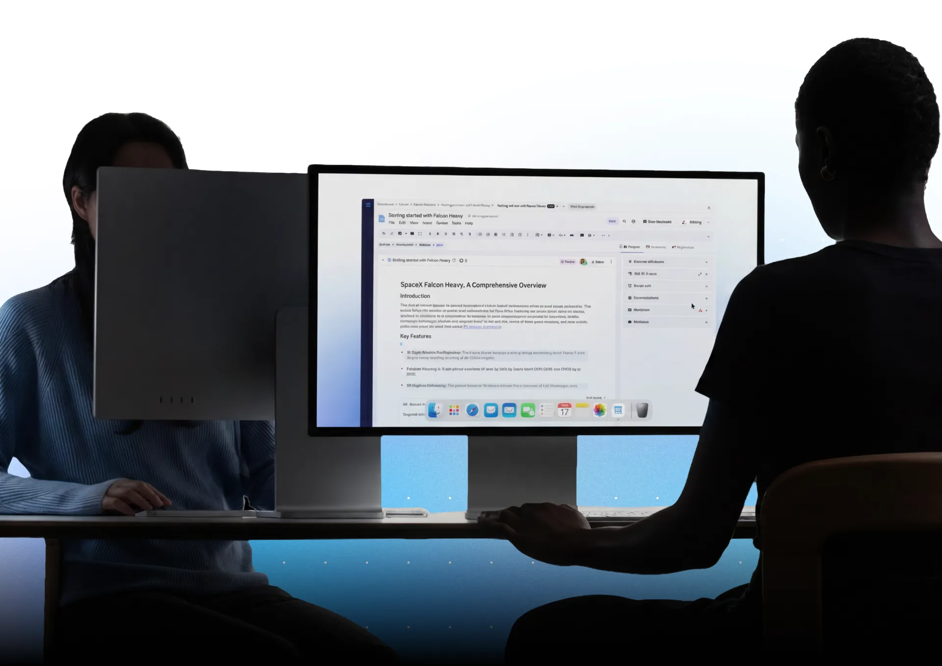 Two people working in Paligo on a large monitor