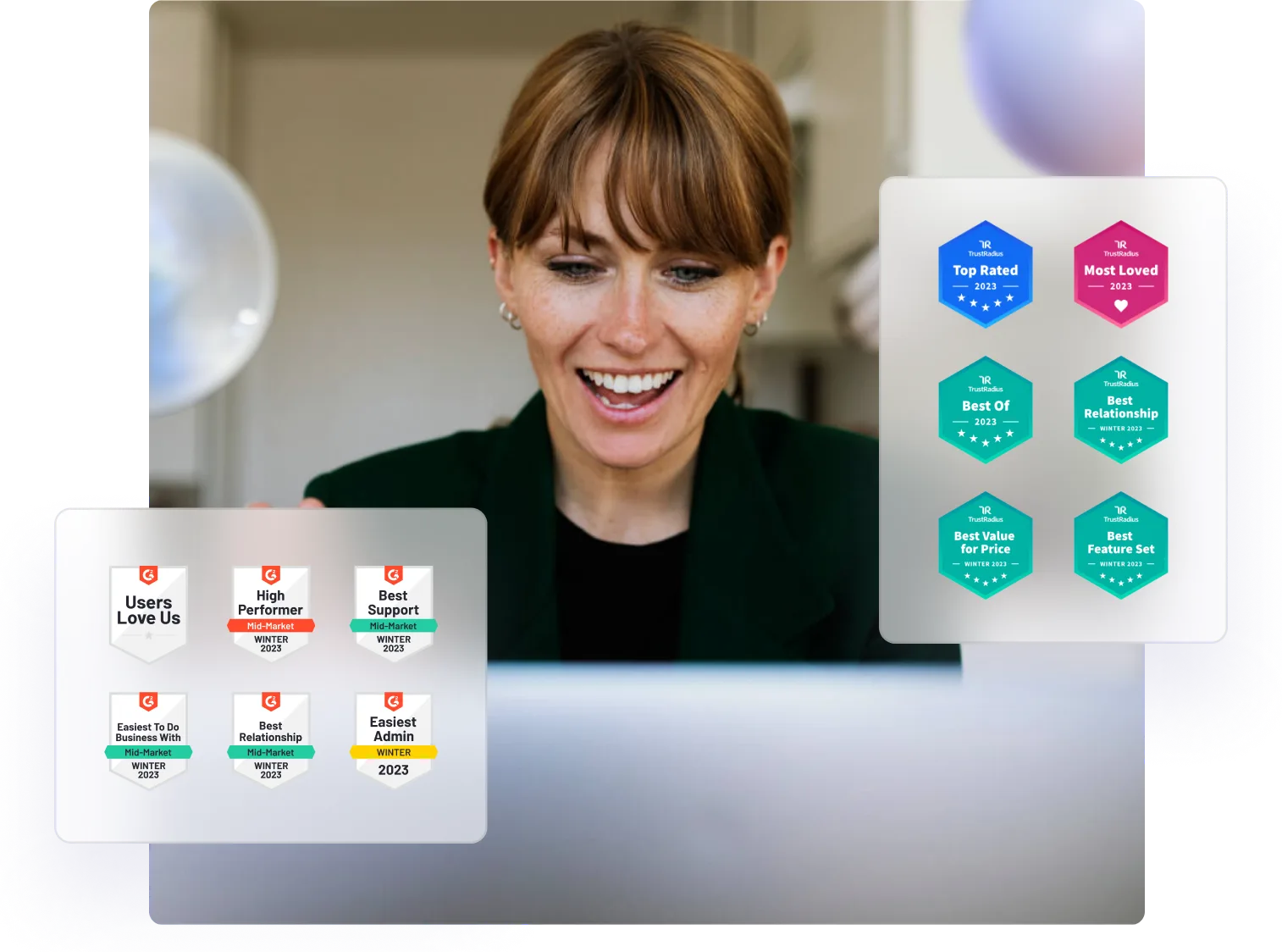 Smiling woman at a laptop, with G2 and TrustRadius 2023 award badges